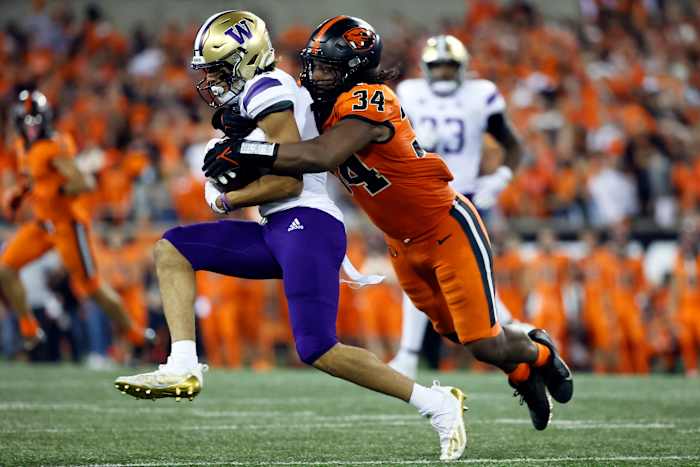 Washington Huskies wide receiver Jalen McMillan (left) is tackled by Oregon State Beavers inside linebacker Avery Roberts (34).